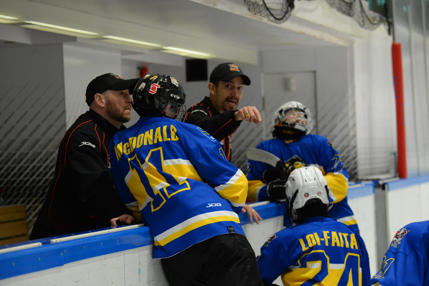 Coach training young hockey players
