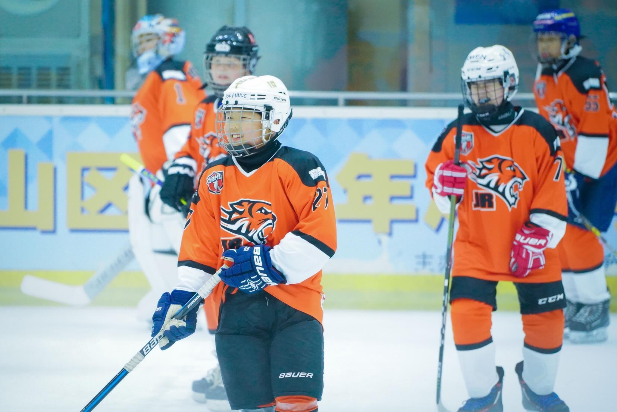Happy young hockey players at Learn to play class