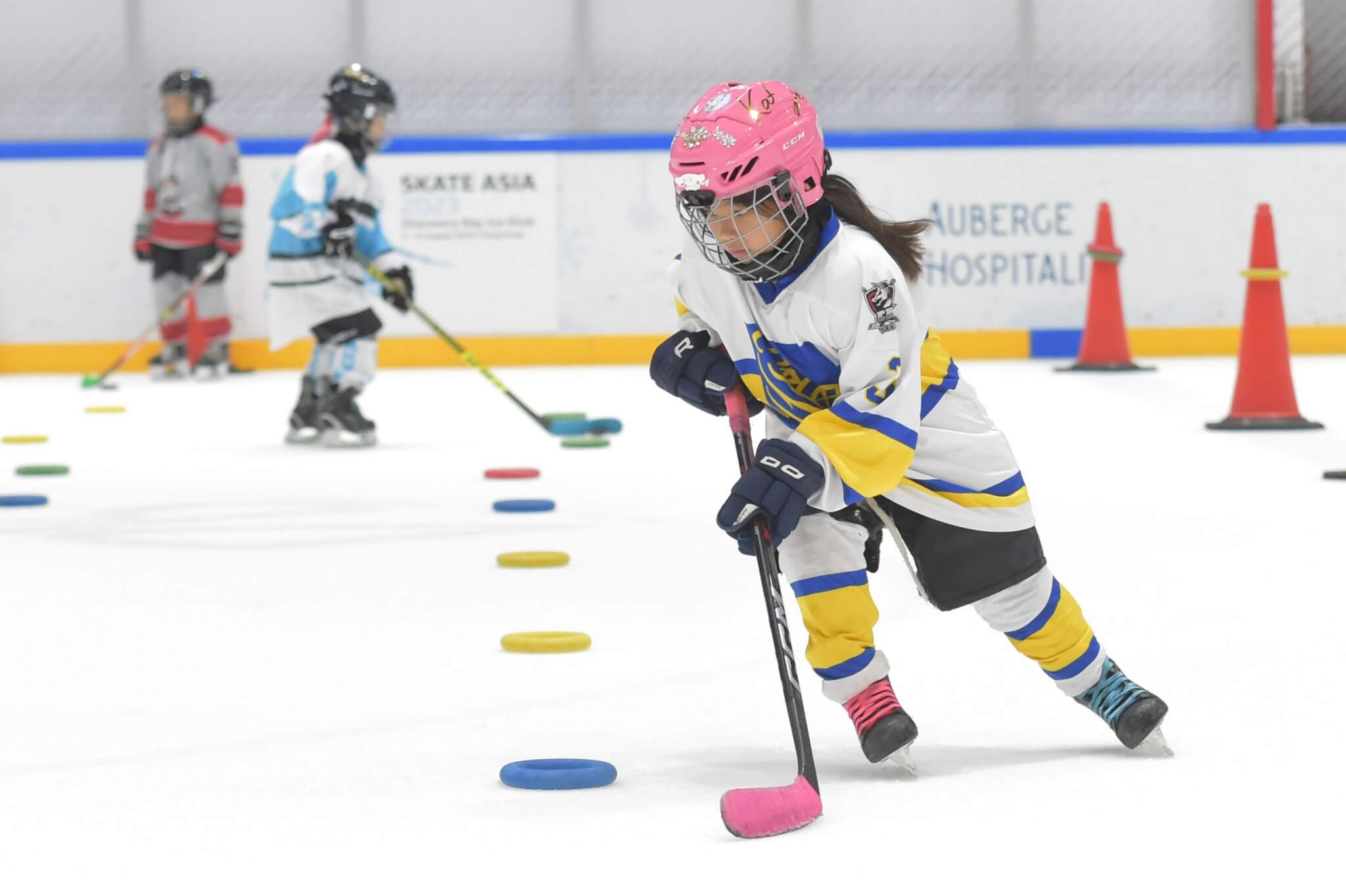 A young girl hockey player training