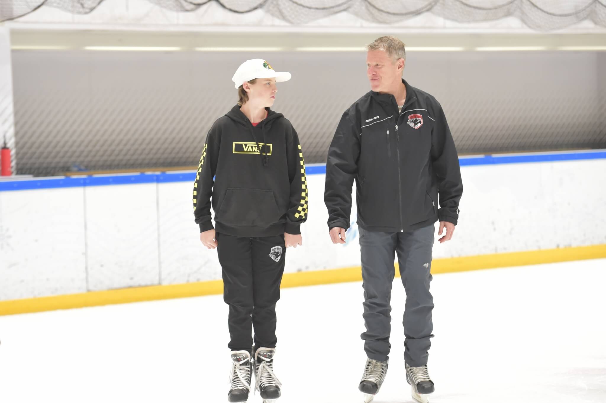 A young man and a mature man at the Discovery Bay Ice rink